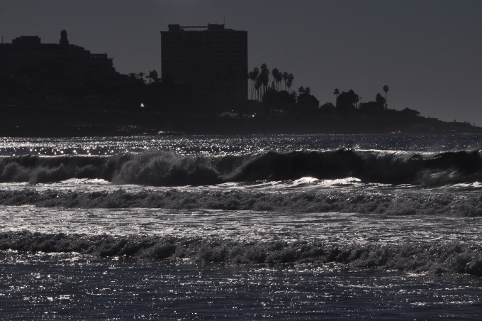 waves with La Jolla town in background